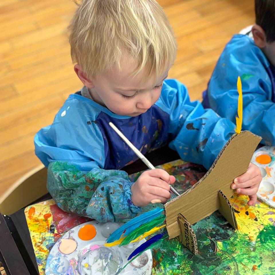 Toddlers painting at easels in art class at FiDi preschool