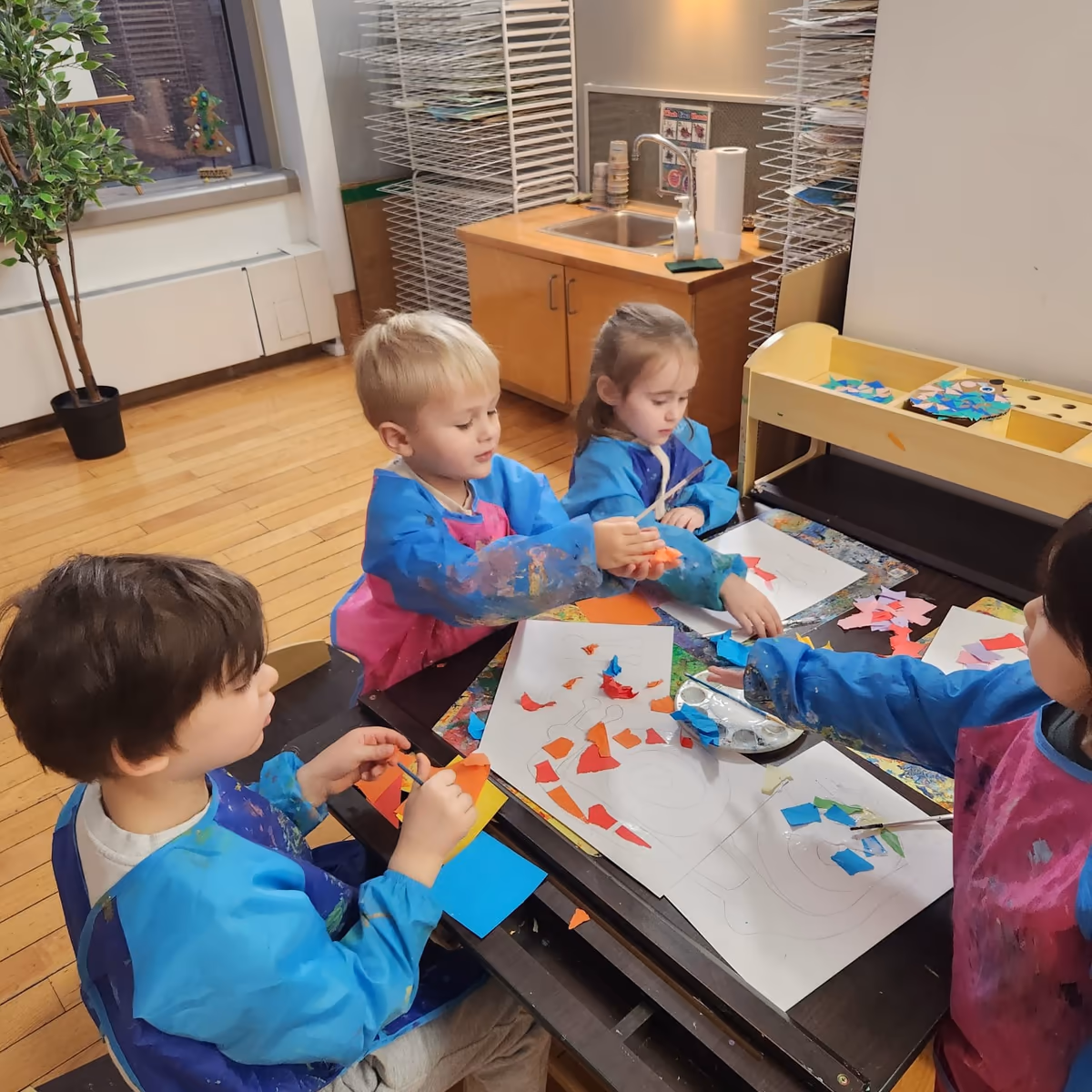 Kids painting a mural in an art class at a preschool in Financial District.