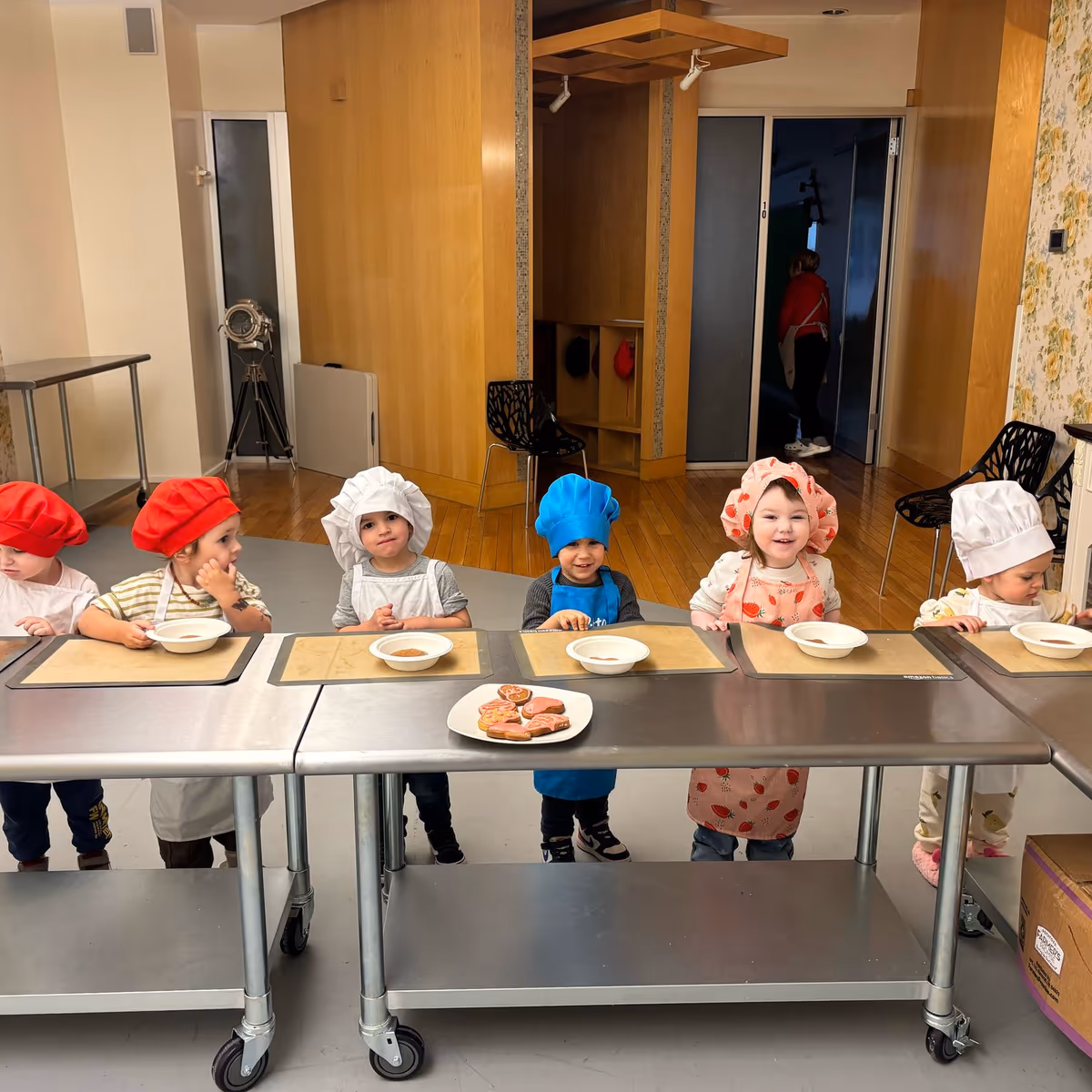 Children mixing ingredients in a cooking class at a downtown Manhattan preschool.