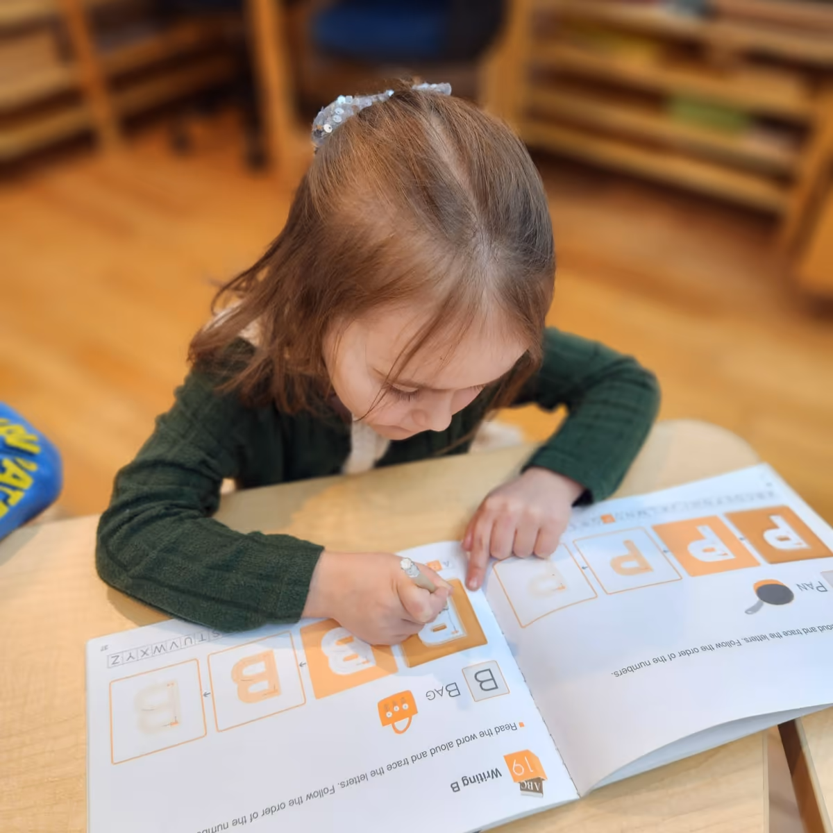 Teacher reading a Spanish book to children at a preschool in downtown Manhattan.