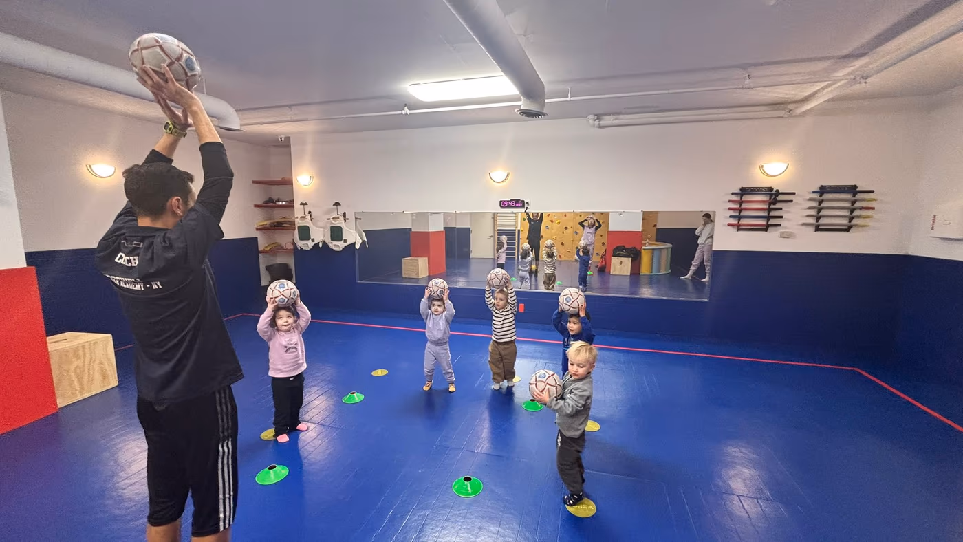 Child kicking soccer ball at Golden Minds Prep